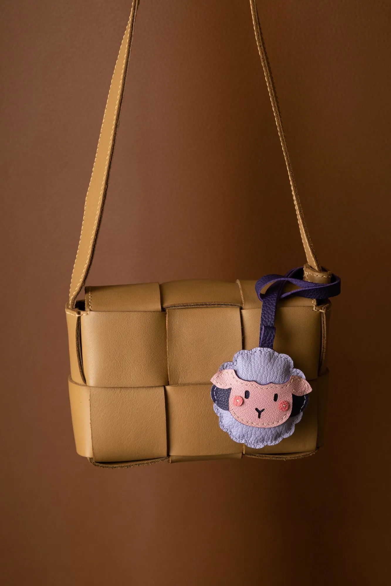 Ảnh Lifestyle Charm đeo túi da hình chú cừu phối nhiều màu - Koi Leather