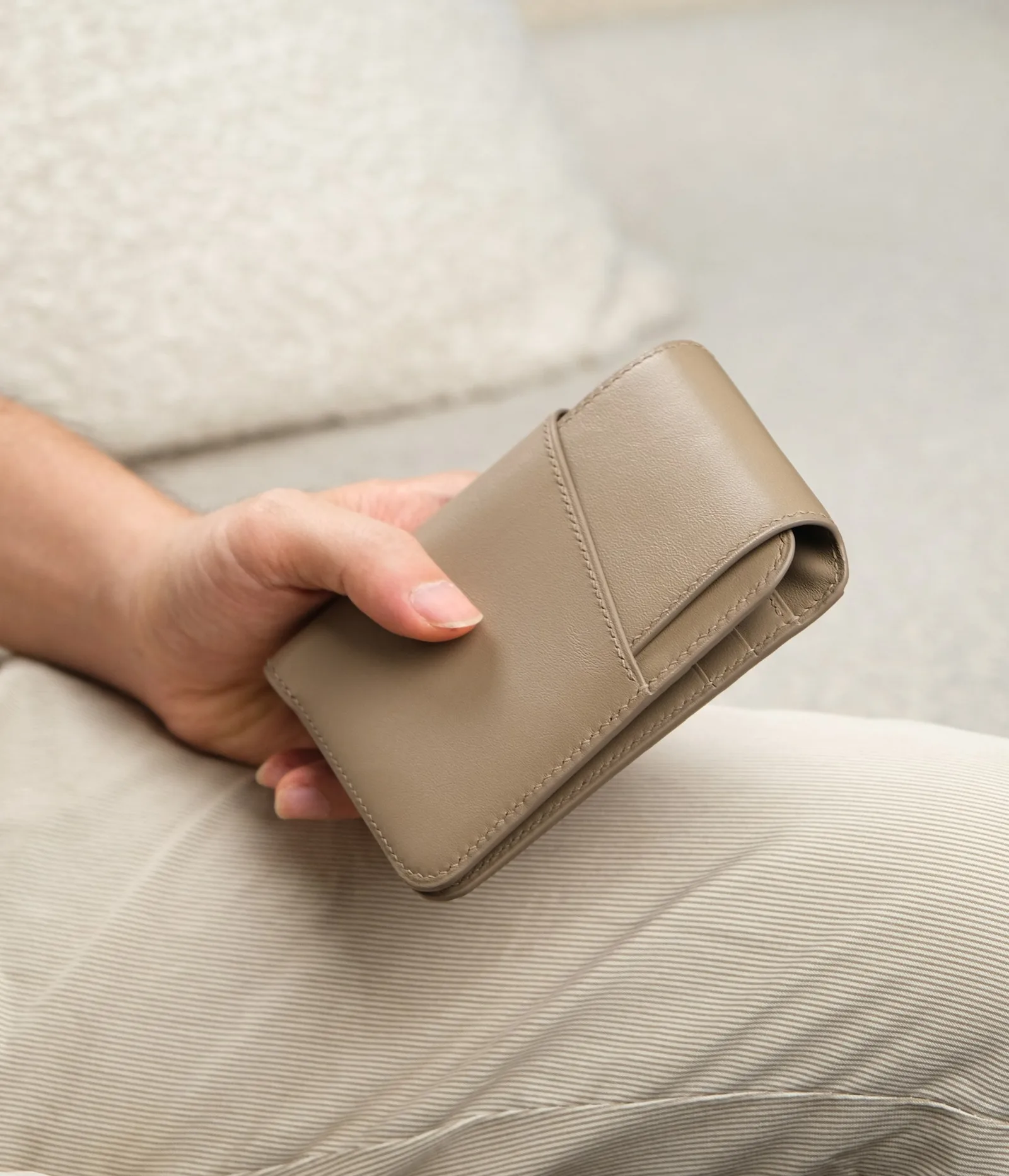 Ảnh Lifestyle Ví gập ba da Swift màu xám taupe nắp cài - Koi Leather