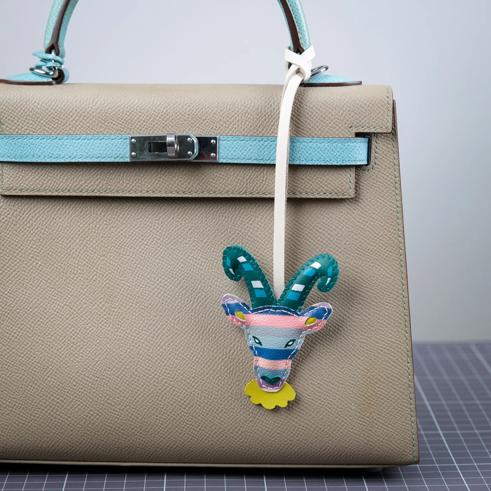 Ảnh Lifestyle Charm da đeo túi hình đầu dê phối màu thủ công - Koi Leather