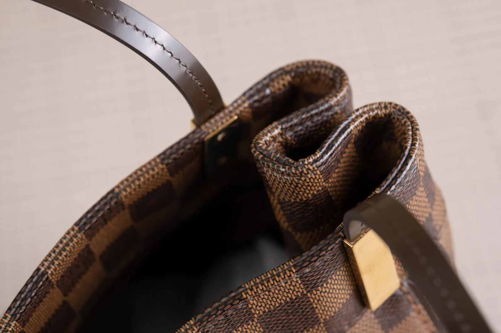 Cận cảnh đường chỉ may và sơn cạnh quai da mới ráp vào khoen túi Louis Vuitton Chelsea
